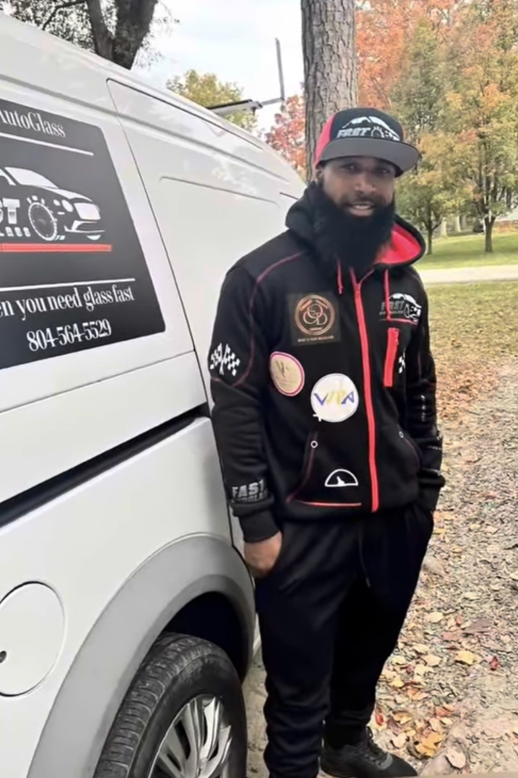 Collin Morse beside a Fast AutoGlass service van